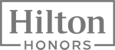 This is the logo of Hilton Honors, featuring the text "Hilton Honors" in a rectangular frame on a black background.